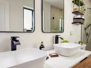 a bathroom with a large white sink and mirrors at King Comfort Suite Kitchen Wi-Fi Parking in Pembrook Pines +10 photos