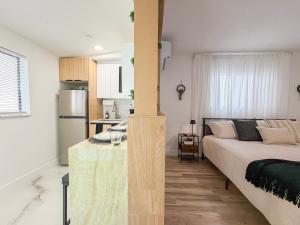 a living room with a bed and a kitchen at King Comfort Suite Kitchen Wi-Fi Parking in Pembrook Pines