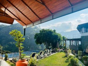a view of a resort with chairs and a pool at Misty Hills Ella Resort in Ella