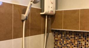 a blow dryer on the wall of a bathroom at Pawa Place (By Inpawa) in Ban Phai +41 photos
