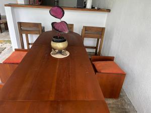 a wooden table with a plant in a vase on it at Olympus House in Mirissa +27 photos