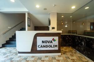 a lobby with a nova cardilimum sign on a counter at Treebo Premium Nova Candolim in Candolim