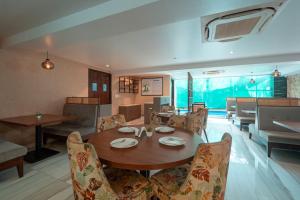 a dining room with a table and chairs at Treebo Premium Nova Candolim in Candolim