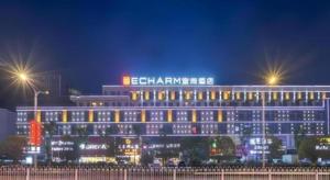 a large building with lights in front of it at night at Echarm Hotel Enshi Cultural Center Xintiandi in Enshi