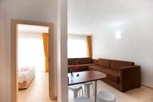 a living room with a couch and a table at Begonville Apart Hotel in Side