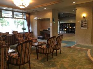 een restaurant met stoelen en een tafel in de lobby bij Breezbay Hotel & Resort Gero in Gero