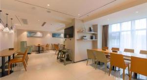 City Comfort Inn Shiyan High-speed Railway Wanda Plaza في Shiyan: غرفة طعام مع طاولة طعام وكراسي