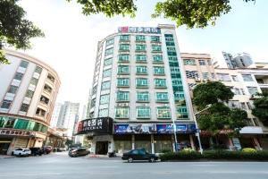 a tall building with a car parked in front of it at Borrman Hotel Yunfu Xinxing County Bus Station in Xinxing