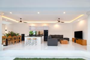 a living room and kitchen with a couch and a table at Villa Mia Seminyak - Boutique Villas - I in Seminyak