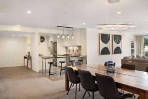 a dining room and living room with a table and chairs at THE SHOTOVER Central Queenstown Luxury in Queenstown