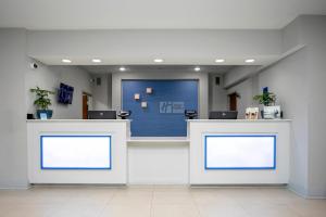 a reception counter in a hospital with two windows at Holiday Inn Express & Suites Jacksonville - Atlantic Beach by IHG in Jacksonville +144 photos