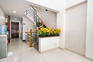 a hallway with a staircase with a potted plant at Collection O Dinh Dinh Hotel - Near Tan Son Nhat Airport in Ho Chi Minh City