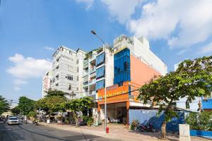 a building on the side of a city street at Collection O Dinh Dinh Hotel - Near Tan Son Nhat Airport in Ho Chi Minh City