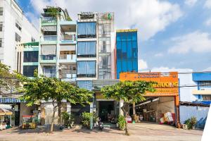 a tall building with an orange sign in front of it at Collection O Dinh Dinh Hotel - Near Tan Son Nhat Airport in Ho Chi Minh City