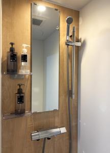 a mirror on the wall of a bathroom at Frasis in Wada