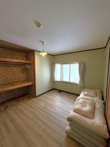 an empty room with a bed and a window at Frasis in Wada +18 photos