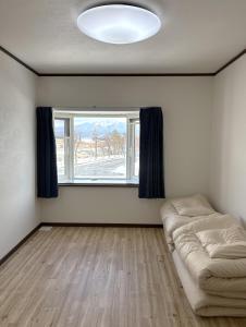 a living room with a couch and a window at Frasis in Wada