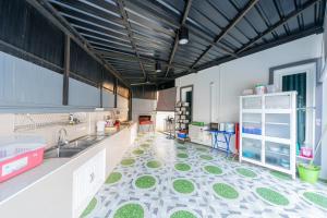 a kitchen with a floor with green and white tiles at Cocktail Poolvilla Pattaya in Na Jomtien