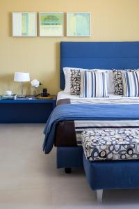 A bed or beds in a room at Villa Gervasio Rooms