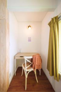 una scrivania in una piccola stanza con una sedia di Matsumoto Inn a Matsumoto