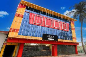 a building with red windows and a sign on it at Collection O Dattapukur Railway Terminal Kolkata in Bārāsat +23 photos