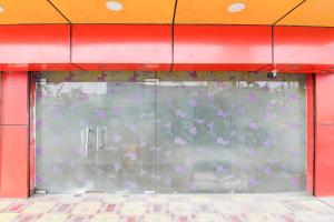a glass door with purple flowers on it at Collection O Dattapukur Railway Terminal Kolkata in Bārāsat
