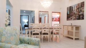 a dining room with a table and chairs and a chandelier at Cunucu Villa with Private Jacuzzi in Soledad