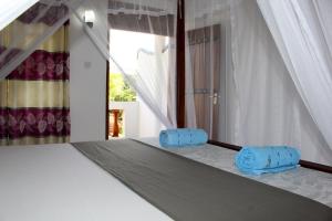 Postel nebo postele na pokoji v ubytování Orchid Rest