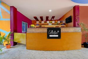 a restaurant with a counter with a sign on it at Collection O Sirkazhi Formerly Navagiraga Resort in Vaithīsvarankoil