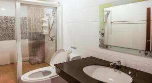 a bathroom with a sink and a toilet and a mirror at Triple Rund Place Hotel in Patong Beach +76 photos