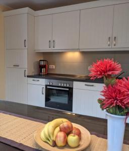a plate of fruit on a table in a kitchen at Unter den Kiefern 62 in Röbel