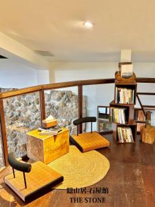a living room with a stone wall at 隱山居 海景包棟2-10人 in Jiufen