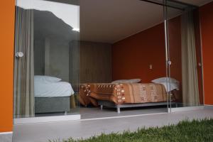 a bedroom with a bed and a glass wall at Hotel Vallehermoso Lunahuana in Lunahuaná +50 photos