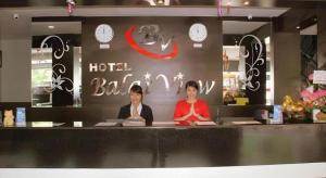 two people sitting at a counter in a hotel room at Balai View Hotel in Tanjung Balai Karimun