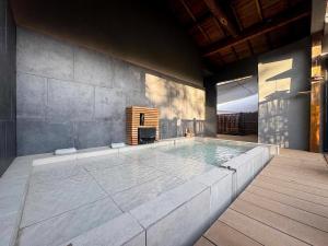 a large swimming pool in a room with at TIMeSCAPE -hakone- in Miyanoshita