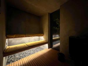 a room with a window with a bench on it at TIMeSCAPE -hakone- in Miyanoshita