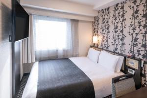 Ένα ή περισσότερα κρεβάτια σε δωμάτιο στο APA Hotel Asakusa Kaminarimon
