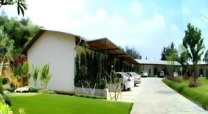 a white building with a car parked in a driveway at Mittraphap Resort in Ban Sathani Bandai Ma +95 photos