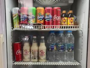 a refrigerator filled with different types of drinks at Iyara Residence in Trat +55 photos