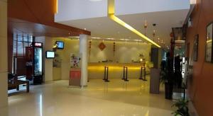 a lobby of a building with a yellow wall at Jinjiang Inn Guangzhou Liwan Caihongqiao Metro Station in Guangzhou