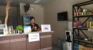 a woman sitting at a counter in a room at Hide & Seek Resort Krabi in Ban Khlong Chi Lat