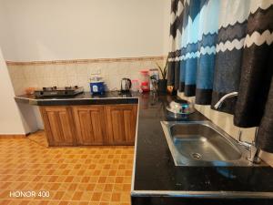a kitchen with a sink and a counter top at Hilltop Haven in Mirissa +21 photos