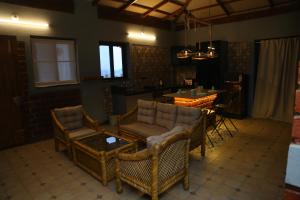 a living room with wicker chairs and a table at The Loft -Aadhya Homestay Hampi in Munirābād