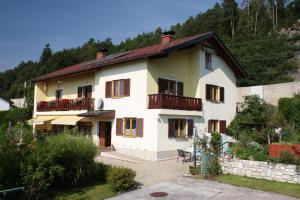 a large white house with balconies on a hill at Haus Babin in Techelsberg am Worthersee