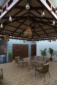 a living room with couches and tables and lights at The Loft -Aadhya Homestay Hampi in Munirābād