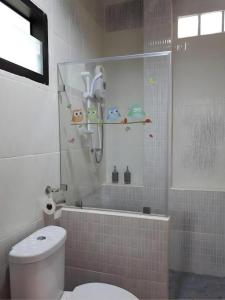 a bathroom with a shower and a toilet and a tub at Baan Bhuriwat Kiriwong in Khiriwong +161 photos