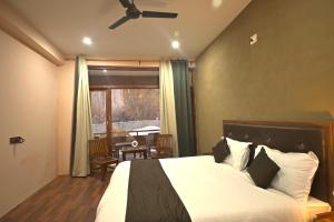 ハンダルにあるThe Syiaのベッドとテーブルと窓のある寝室