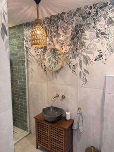 a bathroom with a sink and a chandelier at Boho Home in Veliko Tŭrnovo