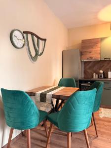 a dining room with a table and green chairs at Boho Home in Veliko Tŭrnovo +25 photos
