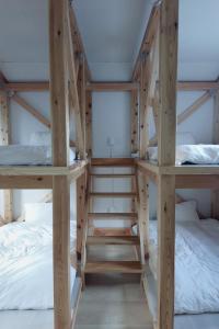 a bunk bed with two bunk beds in a room at やまぽっちYamapochi Cottage in Hakuba